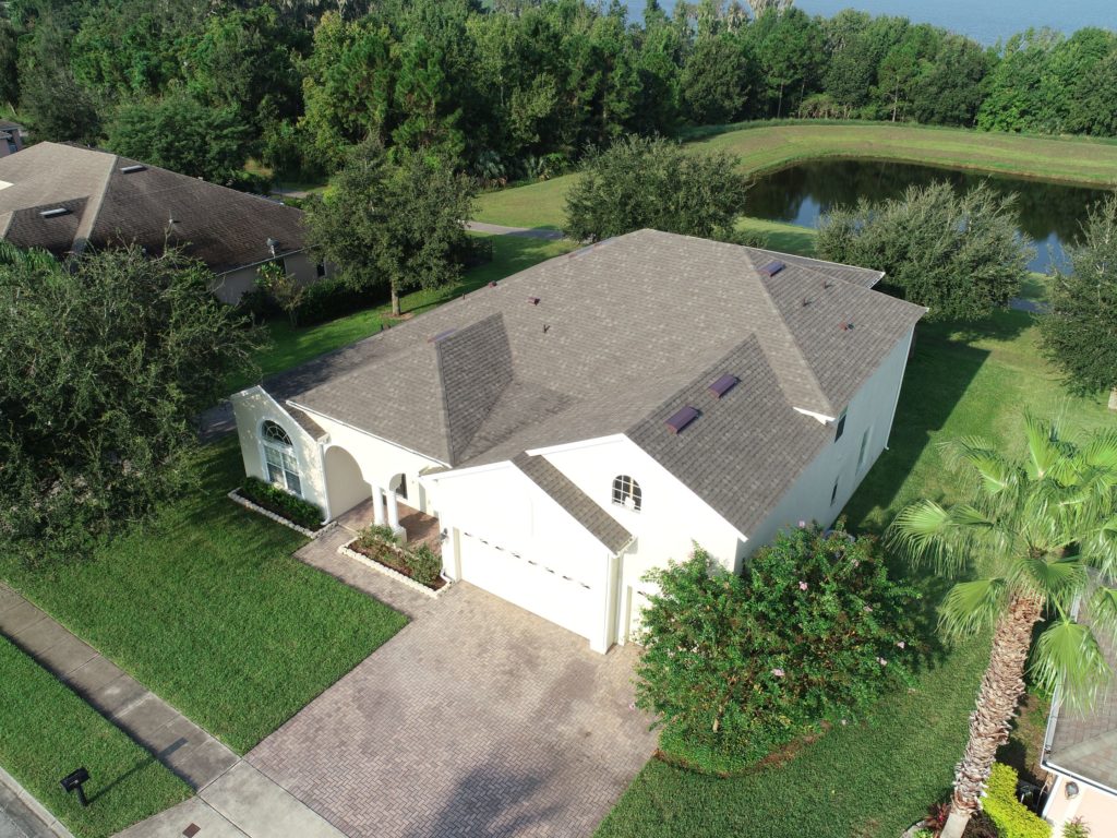 Overhead view of a white house with a shingled roof in Greater Orlando.