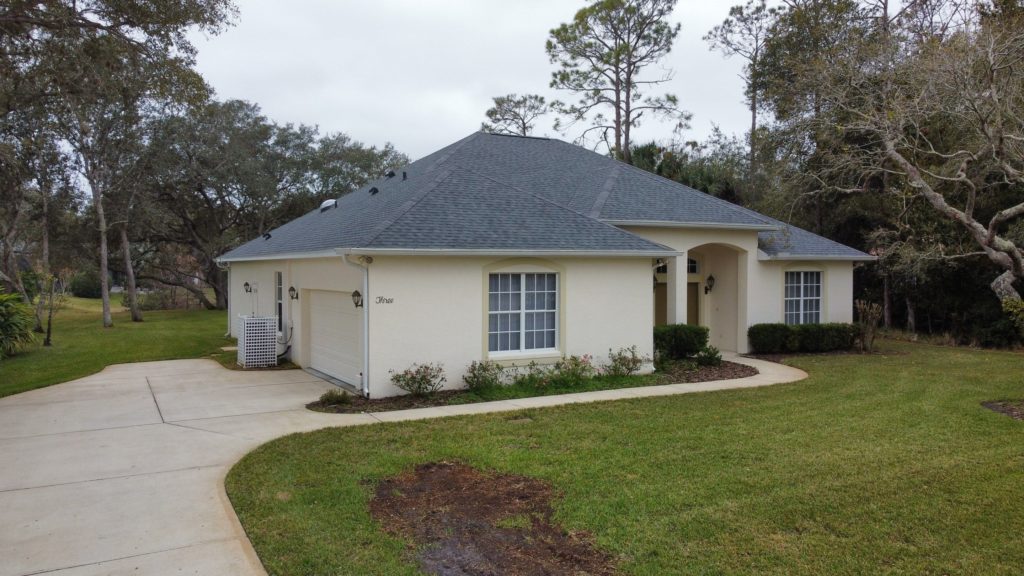Beige house with a shingled roof in Greater Orlando
