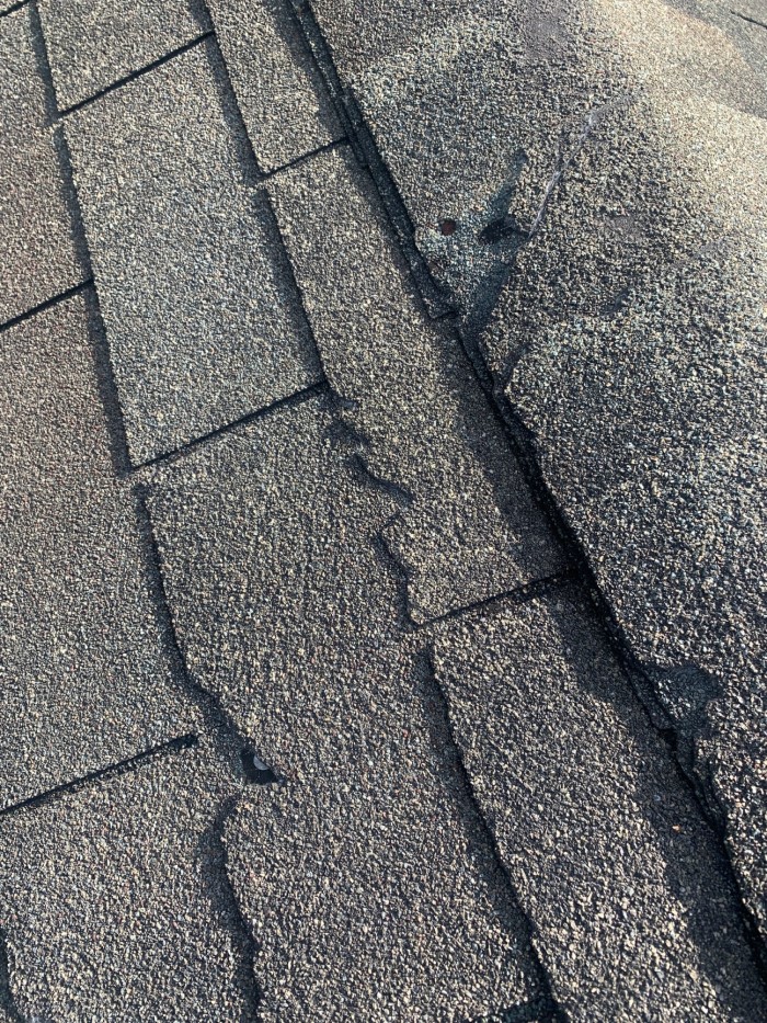 Damaged shingles in need of replacement.