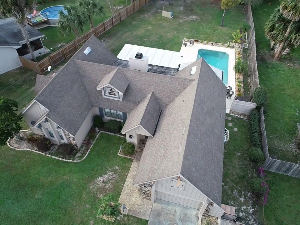 Aerial view of a new gray asphalt shingle roof on a home near Longwood, Florida.