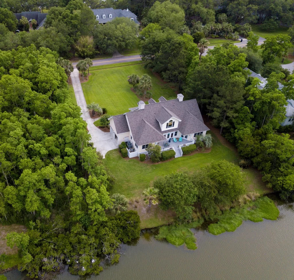 Aerial view of a waterfront home in Florida with a new shingle roof.
