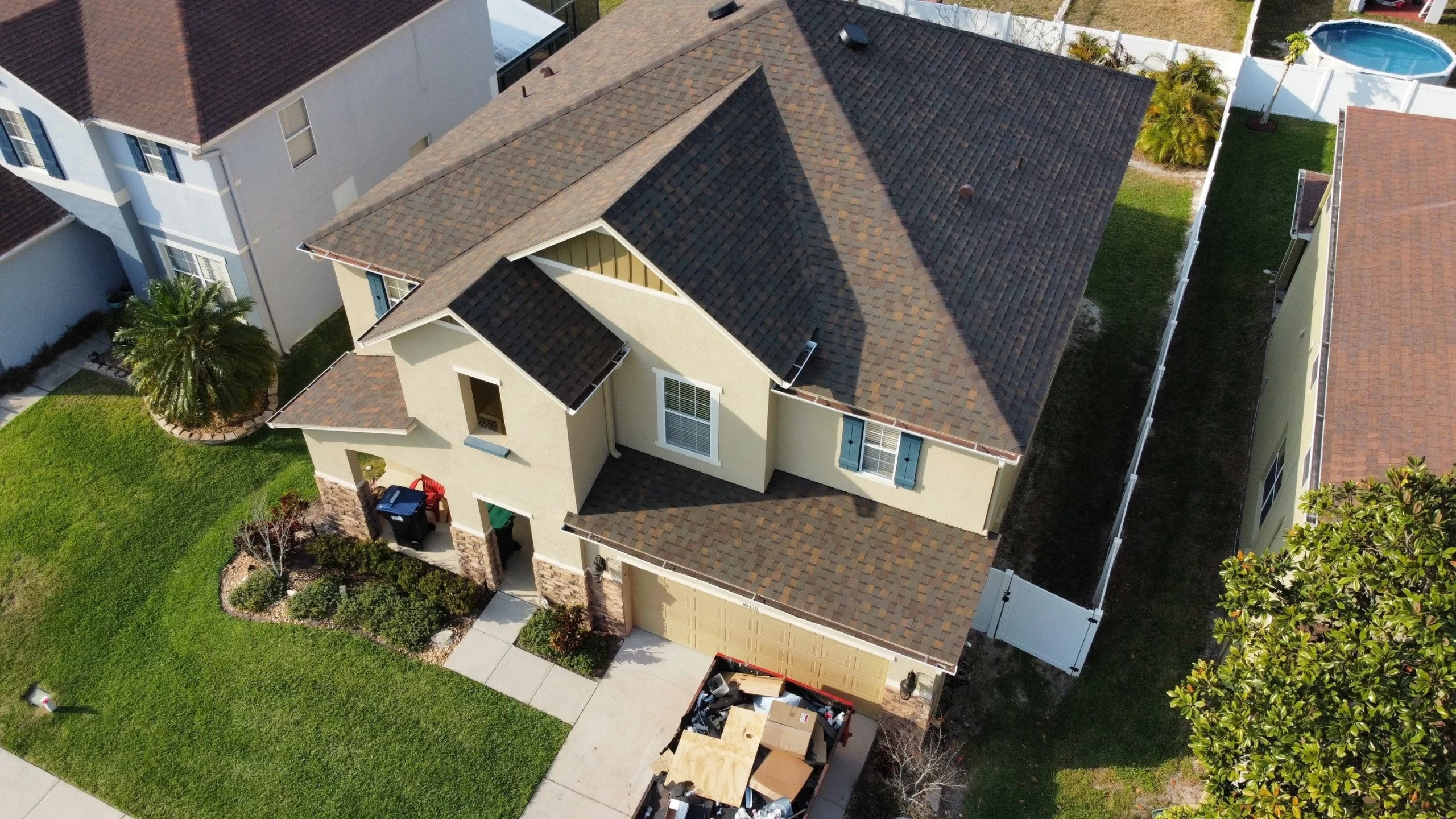 Aerial view of a residential home in Maitland, Florida, featuring a brand new roof installation by Nine Square Roofing, highlighting the precision and quality of the work.